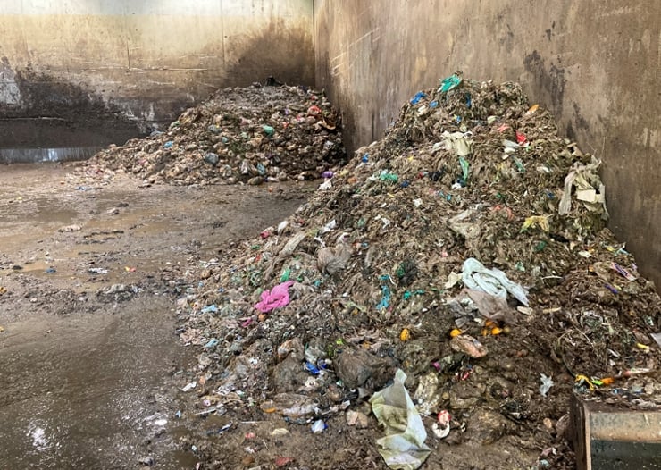 To hauger med avfall i plastsekker av ulike farge. 